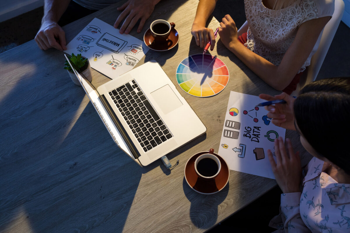 Executives discussing over laptop during a meeting in office